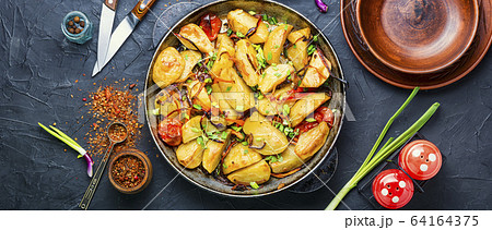 Roasted potato in a frying pan Roasted potato in a frying pan 64164375