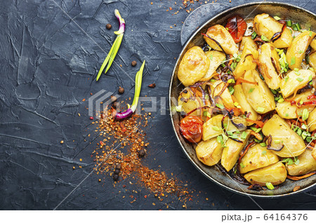 Potatoes fried in pan 64164376