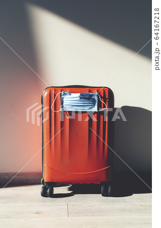 Personal red luggage with protective mask 64167218