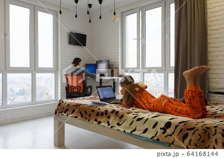 The family is at home, the child lies on the bed 64168144