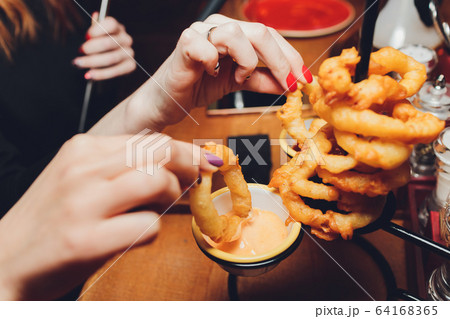 onion rings with ketchup on a dark table. onion rings with ketchup on a dark table. 64168365