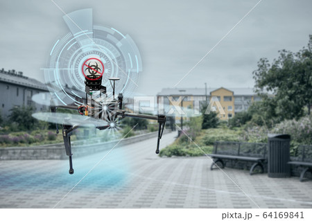 Drone spraying disinfectant on city street during coronavirus pandemic 64169841