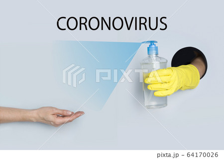 Woman holds out her hand for gel disinfection  64170026