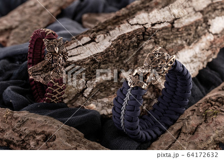 Moscow, Russia - 08/21/2019: Decoration, bracelet for men and women from the paracord on the braided bracelet made of cord 64172632