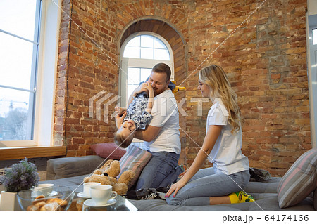 Mother, father and son at home having fun, comfort and cozy concept 64174166