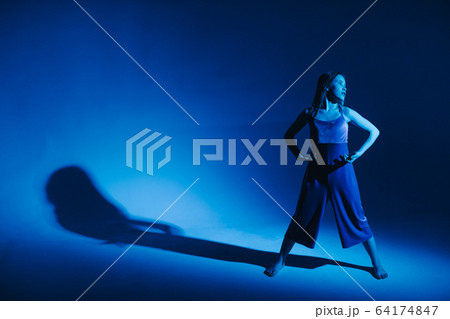 Young stylish girl dancing in the Studio on a colored neon background. Classic dancer. Young stylish girl dancing in the Studio on a colored neon background. Classic dancer. 64174847