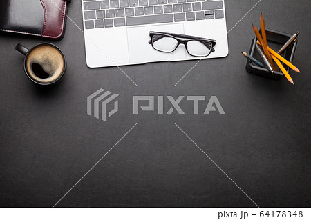 Office desk table with laptop and supplies 64178348