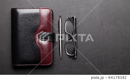 Office desk table with supplies and glasses 64178382