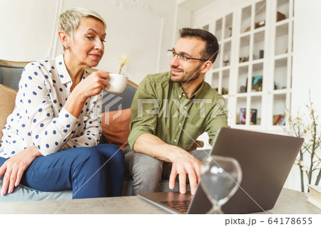 Pleased astrologer looking at his female client 64178655