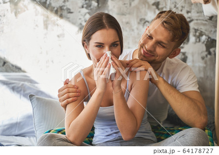 Delighted couple spending their weekend at home Delighted couple spending their weekend at home 64178727