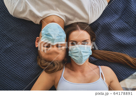 Top view of young people that lying on bed Top view of young people that lying on bed 64178891