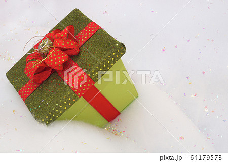 box for present or gift on snow with red ribbon bow box for present or gift on snow with red ribbon bow 64179573