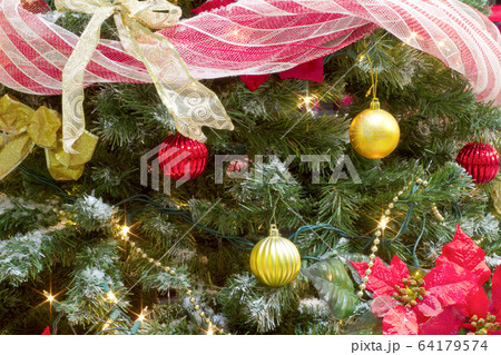 christmas tree garland and bauble decorations with lights and poinsettia 64179574