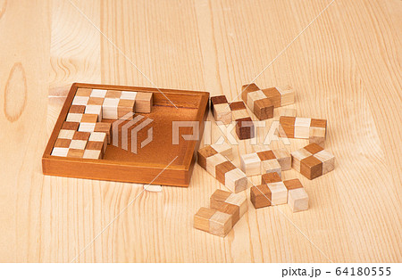 Wooden polymino puzzle on a wooden table. 64180555