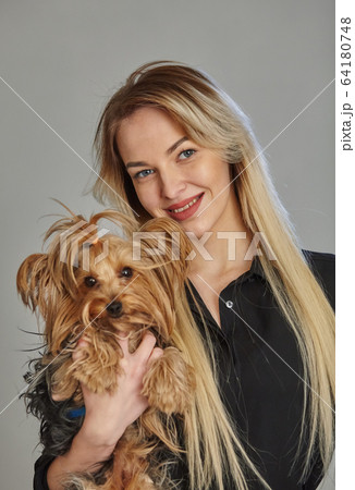 Portrait of young woman with dog 64180748
