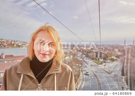 Young pretty woman in cabin of cableway. 64180869