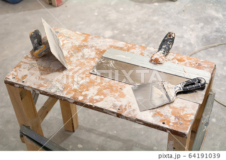 Instruments for renovation apartment. Chisel, trowel, putty knife. The repair process in the room. Instruments for renovation apartment. Chisel, trowel, putty knife. The repair process in the room. 64191039