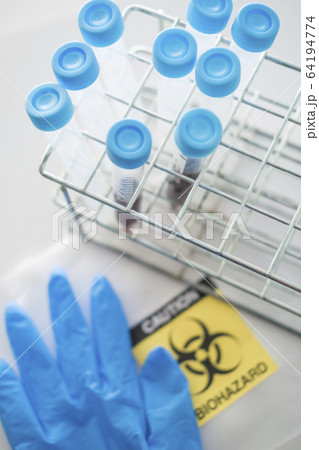 Blood samples with biohazard sign and surgical glove 64194774
