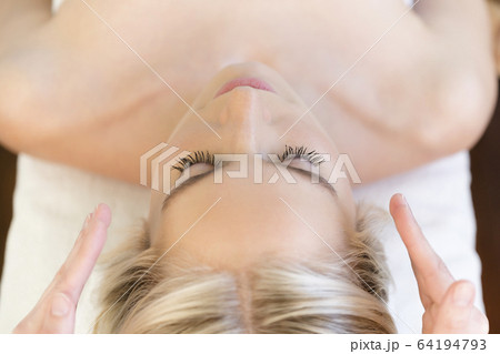 Woman getting head massage during spa treatment Woman getting head massage during spa treatment 64194793