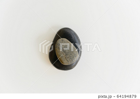 Composition of two stones on white background Composition of two stones on white background 64194879