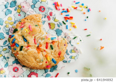 Homemade cookie with colorful sprinkle on floral napkin Homemade cookie with colorful sprinkle on floral napkin 64194892