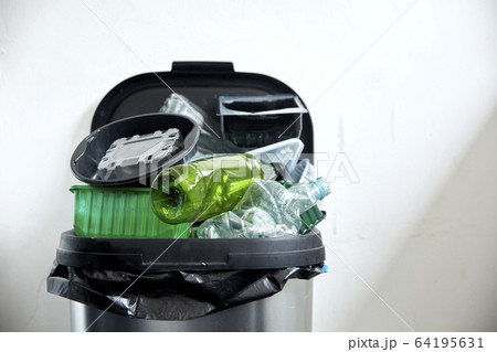 Used plastic containers filling up kitchen dustbin Used plastic containers filling up kitchen dustbin 64195631