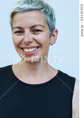 Woman with short grey hair wearing black top smiling at camera. Woman with short grey hair wearing black top smiling at camera. 64195950