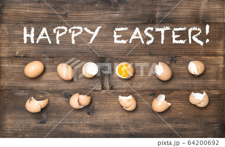 Happy Easter Raw eggs wooden background Happy Easter Raw eggs wooden background 64200692