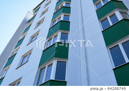 facade of a new multi-storey building with white facade of a new multi-storey building with white 64200740