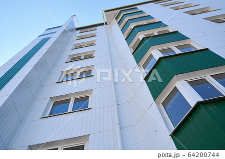 facade of a new multi-storey building with white facade of a new multi-storey building with white 64200744