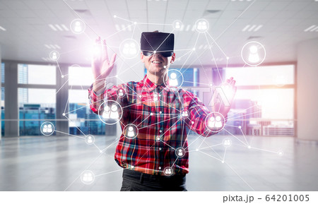 Guy wearing checked shirt and virtual mask reaching hand to touch screen 64201005