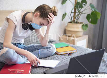 Schoolgirl studing at home 64201329