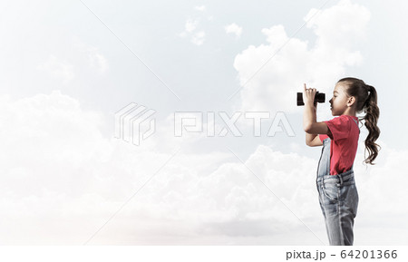Concept of careless happy childhood with girl looking in binocul Concept of careless happy childhood with girl looking in binocul 64201366