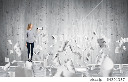 Woman keeping megaphone in hand. 64201387