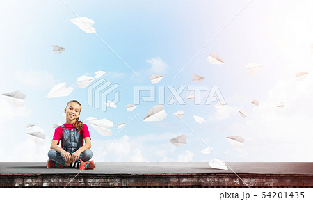 Concept of careless happy childhood with girl of school age smilling Concept of careless happy childhood with girl of school age smilling 64201435