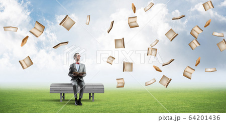 Young businessman or student studying the science and books fly around Young businessman or student studying the science and books fly around 64201436