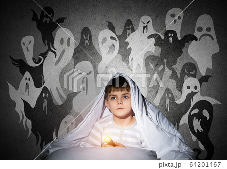 Little child with flashlight hiding under blanket Little child with flashlight hiding under blanket 64201467