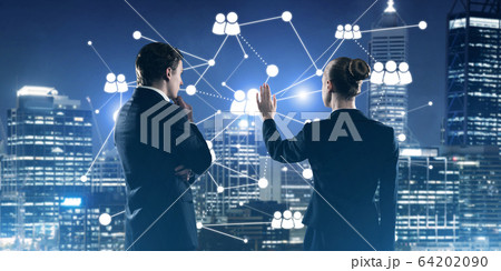 Concept of social connection and networking against night city view and partners working in cooperation Concept of social connection and networking against night city view and partners working in cooperation 64202090