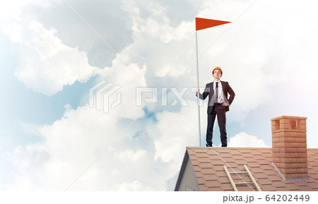 Young businessman with flag presenting concept of leadership. Mi 64202449