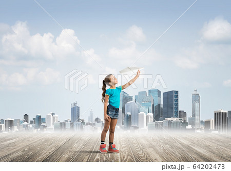 Concept of careless happy childhood with girl dreaming about future 64202473