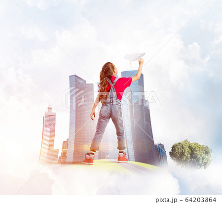 Concept of careless happy childhood with girl dreaming about future Concept of careless happy childhood with girl dreaming about future 64203864