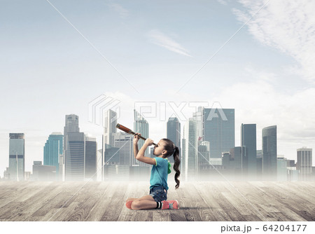Concept of careless happy childhood with girl dreaming about fut 64204177