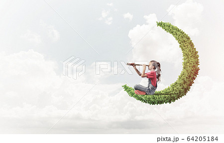 Concept of careless happy childhood with girl on green moon Concept of careless happy childhood with girl on green moon 64205184