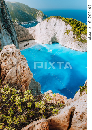 Navagio beach from top rocks at Zakynthos island, Greece. Stranded freightliner ship in unique beautiful blue lagoon and rocky mountains Navagio beach from top rocks at Zakynthos island, Greece. Stranded freightliner ship in unique beautiful blue lagoon and rocky mountains 64206407