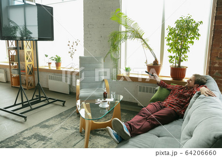 Caucasian man staying at home during quarantine because of coronavirus spreading Caucasian man staying at home during quarantine because of coronavirus spreading 64206660