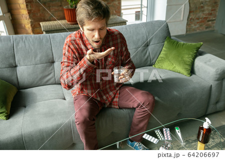 Caucasian man staying at home during quarantine because of coronavirus spreading 64206697