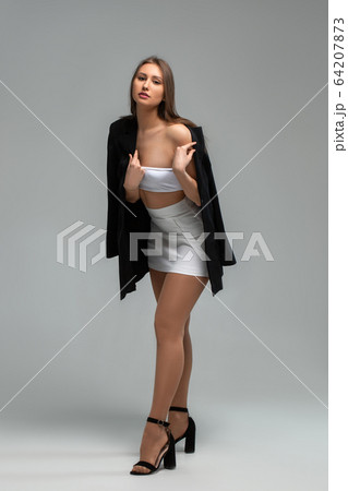 girl in white with a black jacket on a light background 64207873