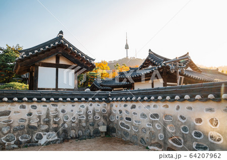 Namsangol Hanok Village, Korean traditional houses and Namsan Seoul Tower at autumn in Seoul, Korea Namsangol Hanok Village, Korean traditional houses and Namsan Seoul Tower at autumn in Seoul, Korea 64207962