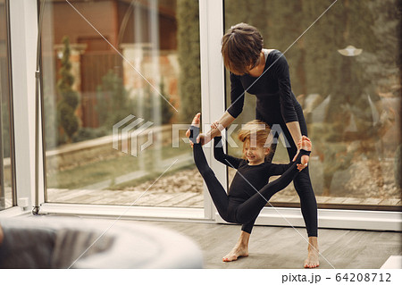Woman with daughter is engaged in gymnastics 64208712