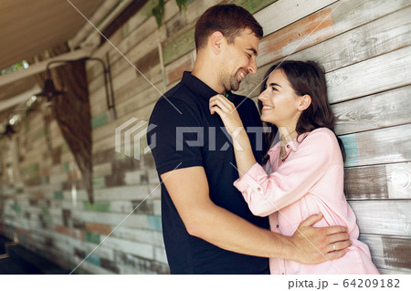 Beautiful couple sitting in a summer cafe Beautiful couple sitting in a summer cafe 64209182